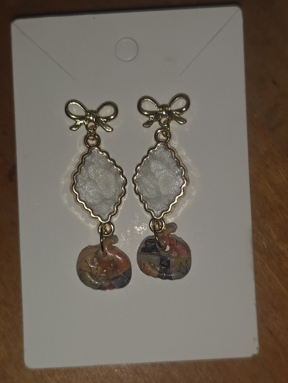 Little Polymer Ckay Pumpkin Earrings Dangling From Comnector And Bow Stud Posts